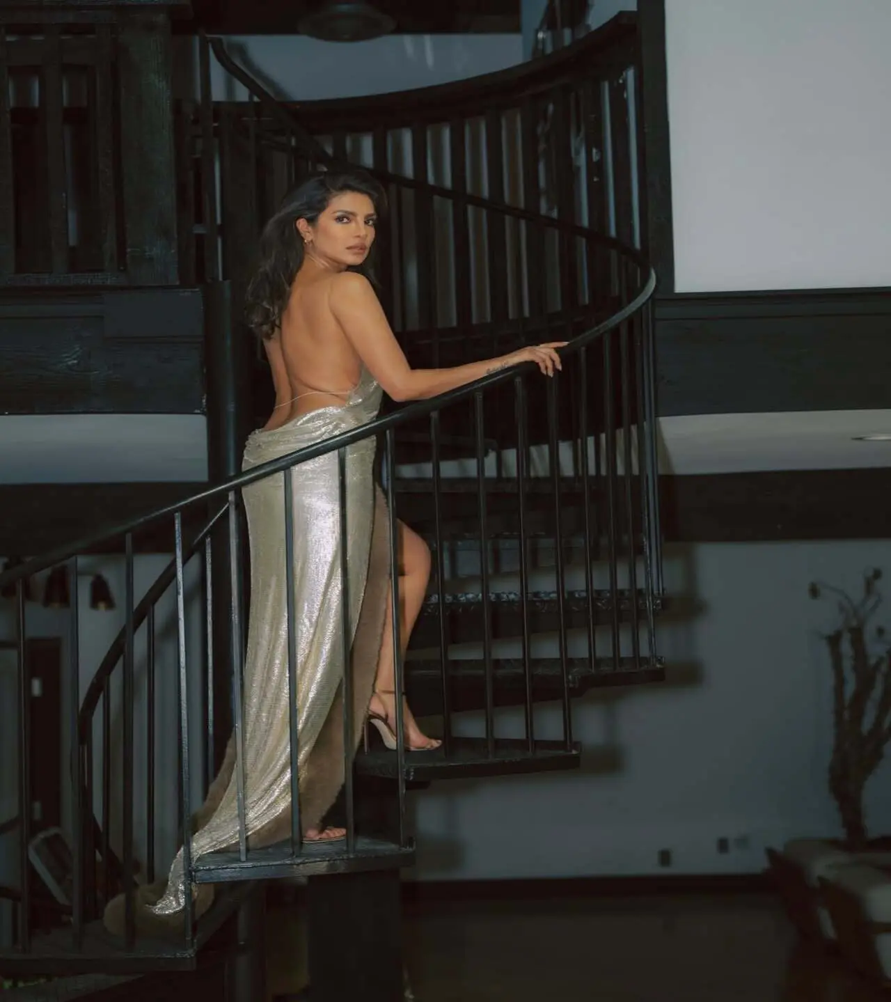 The Barfi actress looks ravishing as she poses on the stairs confidently, showing off her regal, backless outfit in all its glory
